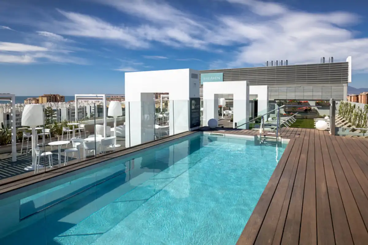 White lounge area and bar beside the B-Heaven rooftop pool in Malaga