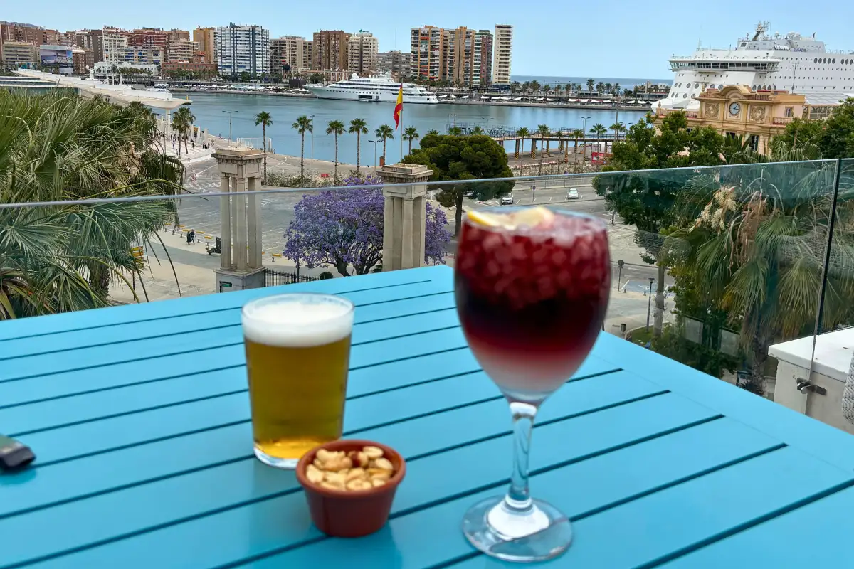 Sangria and beer on a blue table overlooking the port at La Terraza de Valeria in Malaga