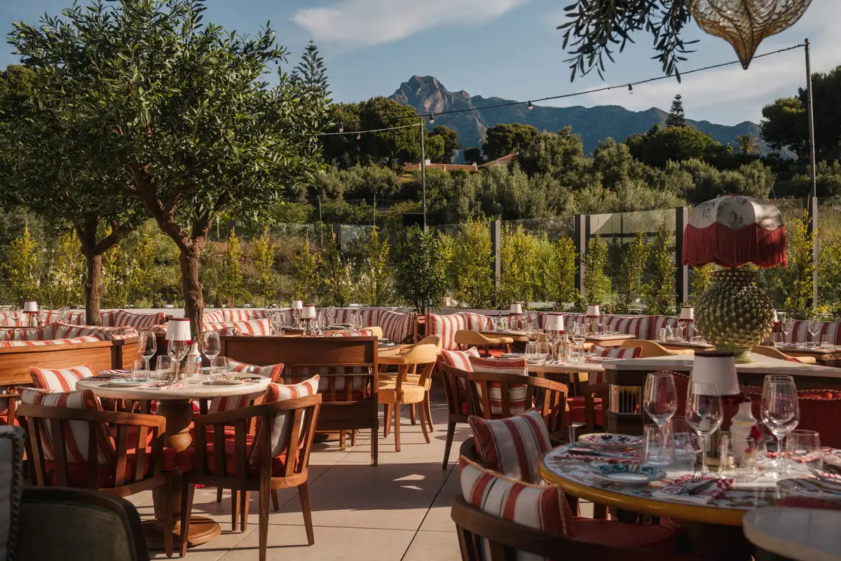 Striped dining terrace with mountain views at Cielo rooftop Marbella