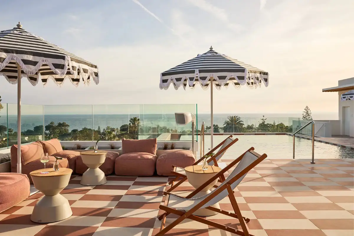 Sunset lounge seating and deck chairs by the pool at Escondido rooftop in Marbella