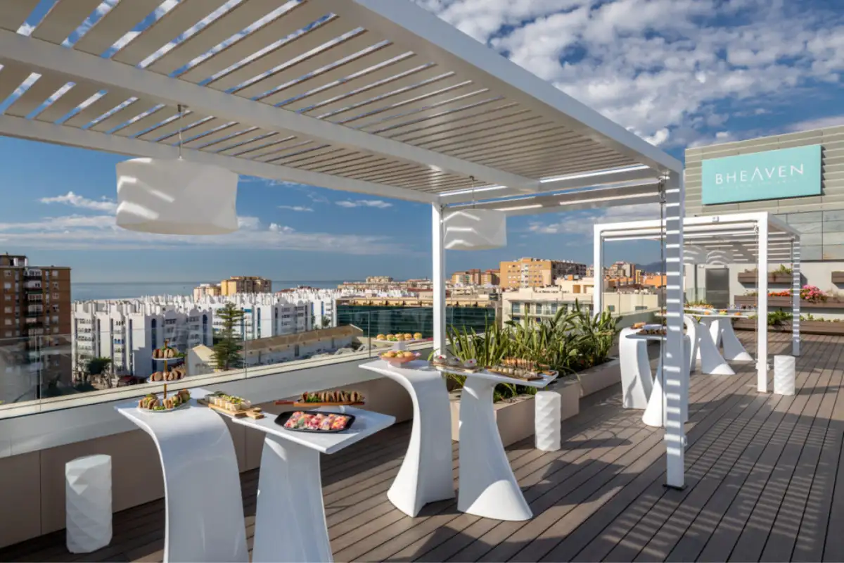 High tables overlooking the city and sea on the B-Heaven terrace Malaga