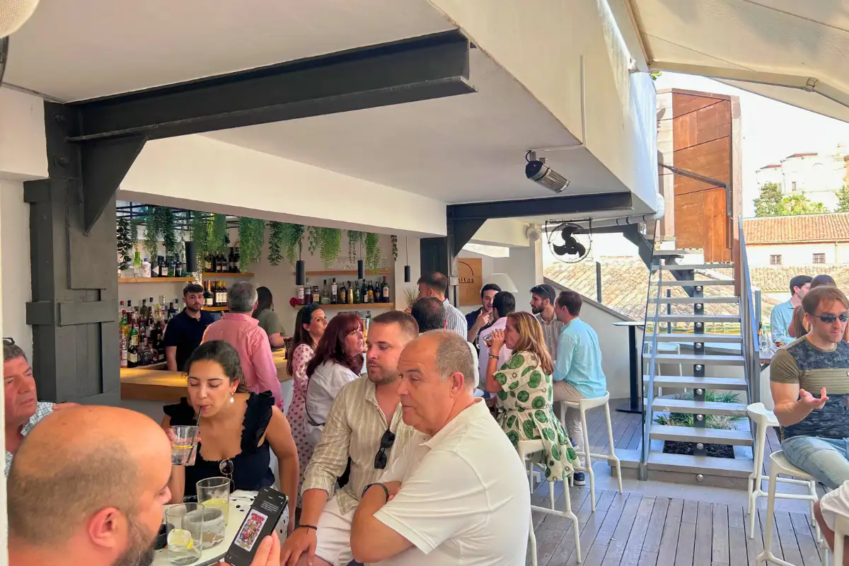 Crowded terrace of drinkers under the bar canopy at Chinitas Urban Malaga