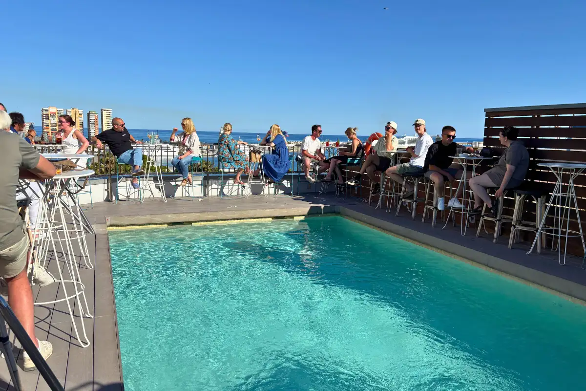 Guests at the rooftop pool bar overlooking the sea at Hotel Molina Lario in Malaga
