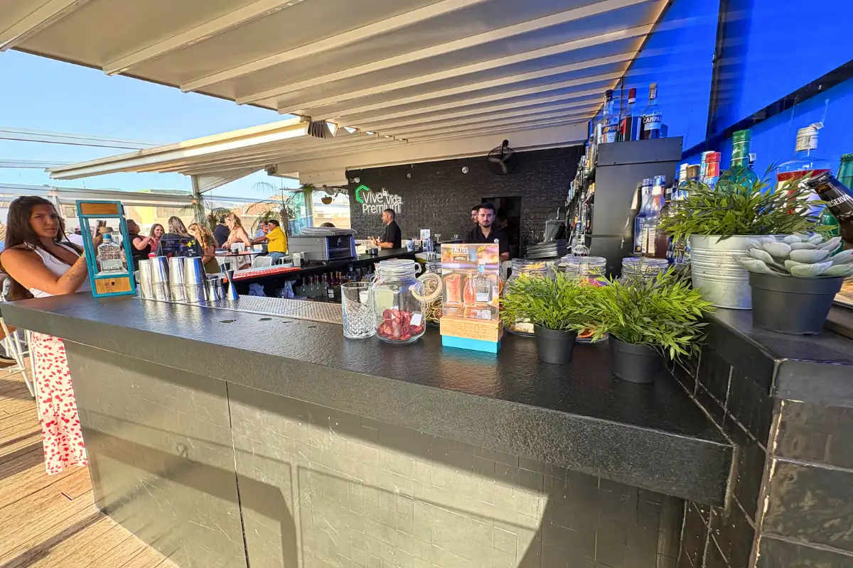 Open-air bar counter with potted herbs at La Terraza de San Juan rooftop in Malaga
